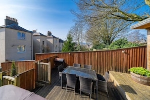 A patio with a table and chairs, a barbecue grill, and a wooden fence. - 3 Bed in Crieff (oc-d672592) (Crieff)