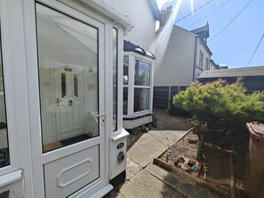 A white building with a large glass door and a small window. There is a number '21' on the door and window. - 2 Bed in Overstrand (oc-s46412) (Overstrand)