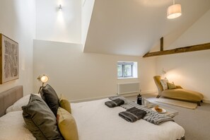 A bedroom with a bed, a chair, a window, and a radiator. - 3 Bed in Letheringsett (oc-m46374) (Letheringsett)