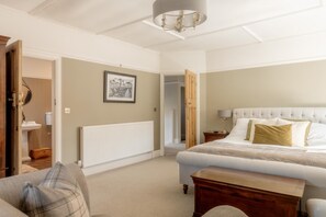 A bedroom with a bed, bedside table, and a radiator. - 4 Bed in Beccles (oc-v46416) (Beccles)