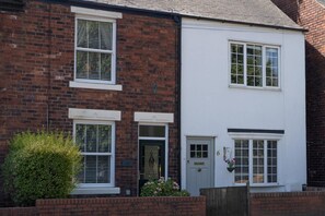 A two-story residential building with a brick facade and white-painted upper section. - 2 Bed in Chesterfield (oc-p46335) (Calow)