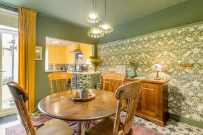 A dining area with a round wooden table, four chairs, and a cabinet. - 2 Bed in Chesterfield (oc-p46335) (Calow)