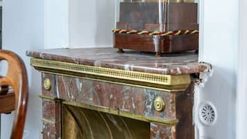 A marble fireplace with a clock on top.