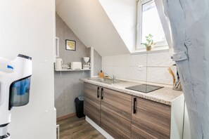 A modern kitchen with a countertop, sink, and wooden cabinets.