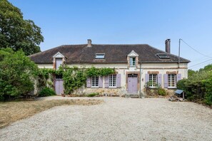 A two-story house with a gravel driveway and a small garden area. - House, Lot | Hot Tub • Fire pit • Art & Deco (Bourdenay)