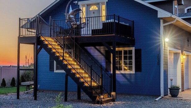 A two-story house with a balcony, a staircase, and a garage. - Kieckhaefer Acres - Honey House (Grand Junction)