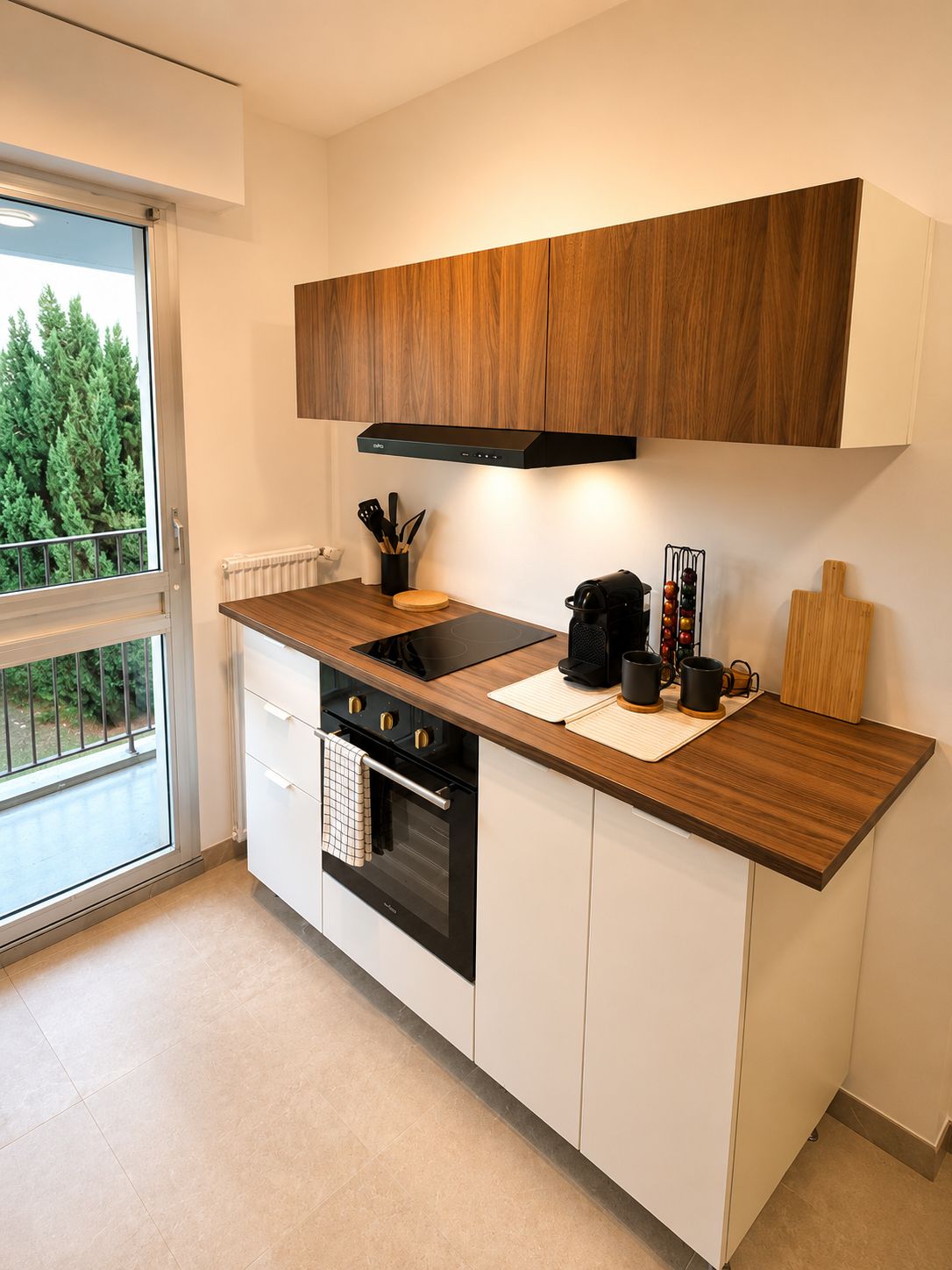 A modern kitchen with a built-in oven, a stovetop, and a black range hood.