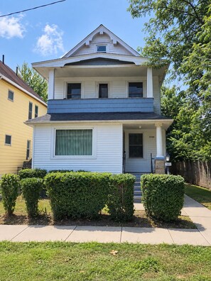 A two-story house with a front porch, a garage, and a mailbox. - Simple & Cozy Cleveland Getaway (Cleveland)