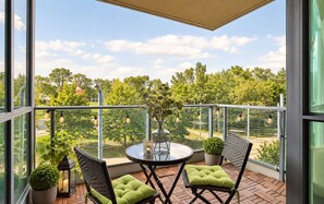 A balcony with a round table, two chairs, potted plants, and string lights. - Spectacular Presidential Loft - Downtown Toronto (Toronto)