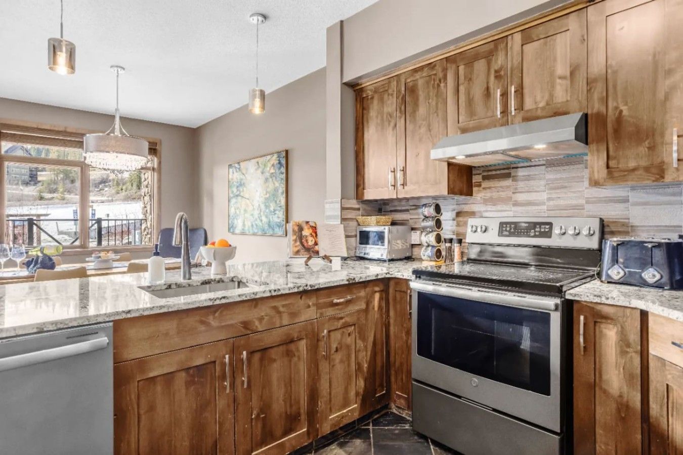 A modern kitchen with wooden cabinets, stainless steel appliances, and a large island with a sink.