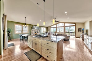 A spacious kitchen with a large island, wooden cabinets, and pendant lighting. - 4 Bedroom Mountain Contemporary Views! (South Lake Tahoe)