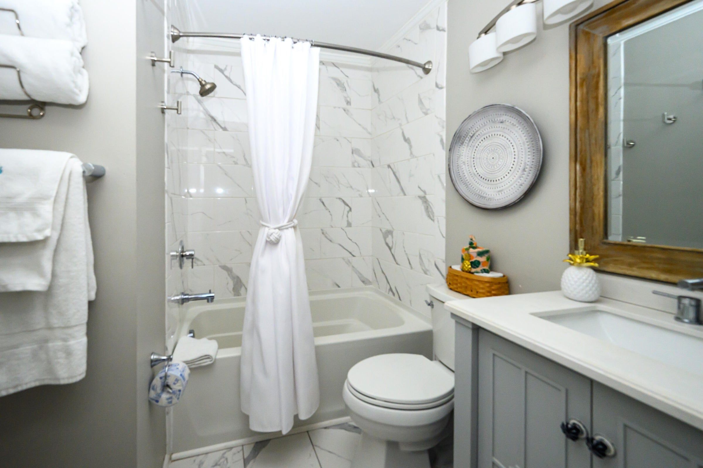 A bathroom with a shower, toilet, and sink.