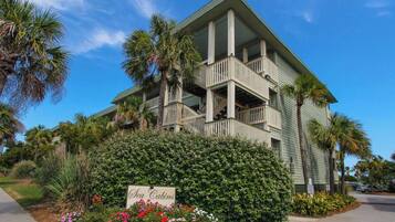 A multi-story building with balconies and a sign reading 'Sea Cabins.'