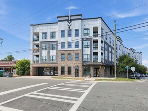 A multi-story building with a commercial space on the ground floor, marked with the number 3630. - Brand-New Luxury Furnished Penthouse in NoDa, MidTerm Rental (Charlotte)