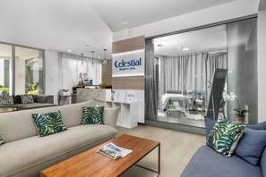Eine moderne Hotelhalle mit einer Couch, einem Couchtisch und einer Rezeption.