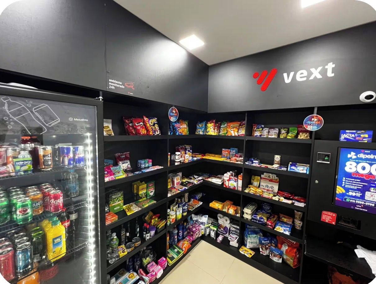A Vectel store with shelves stocked with snacks, beverages, and household items.