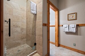 A bathroom with a shower, a towel rack, and a wooden door frame. - King Suite Walkable to Wineries + Private Porch (Fredericksburg)