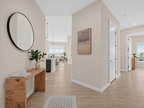 A spacious hallway with a wooden bench, a large mirror, and a potted plant. - Brand-new Luxury Furnished Penthouse in Noda 30 Night Mid-term Rental (Charlotte)