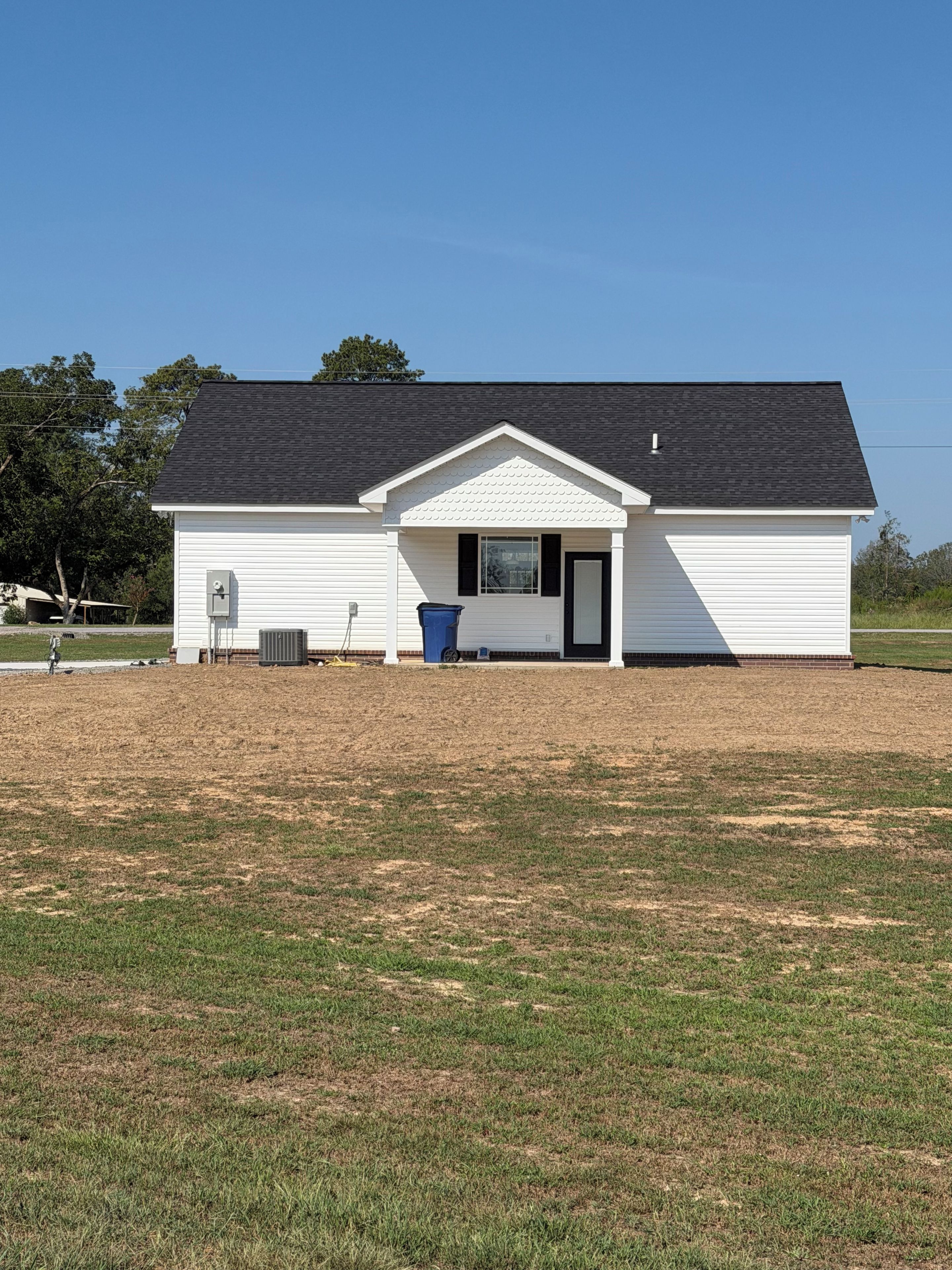 A single-story building with a gabled roof and a small porch.