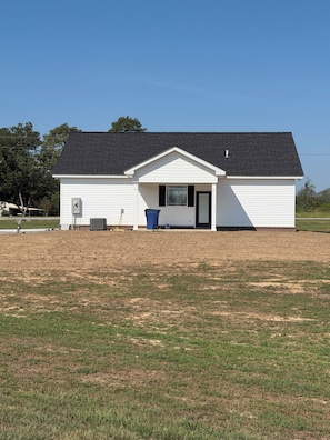 A single-story building with a gabled roof and a small porch.