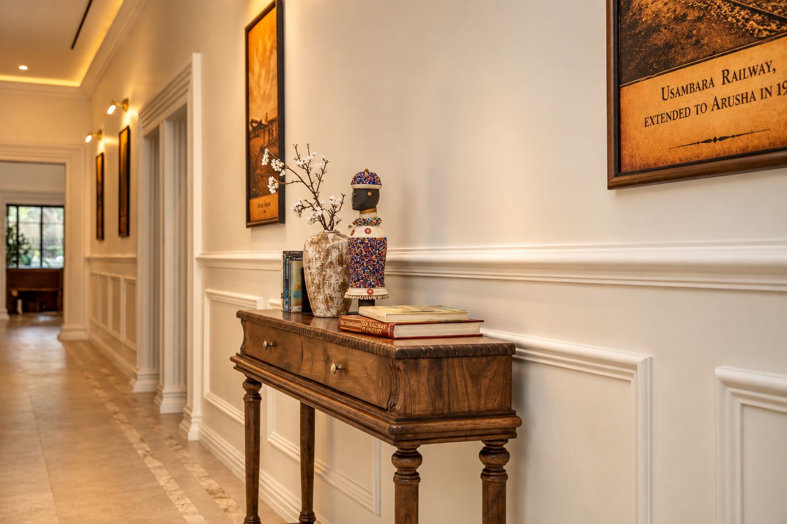 A hallway with a wooden console table, a vase, and a framed picture on the wall.