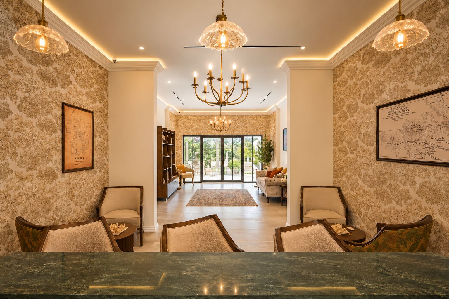 A spacious dining area with a marble table, two chandeliers, and a view to a conservatory.