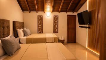A bedroom with two beds, wooden headboards, a flat-screen TV, and a wall-mounted light fixture.