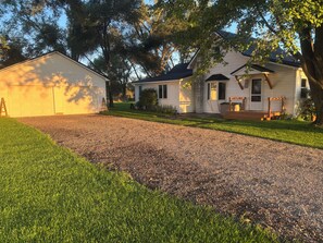 A two-story house with a front porch, a garage, and a well-maintained lawn.