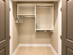 A walk-in closet with a hanging rod and shelves. - Downtown View Retreat | 3BR | 2 Kings (Birmingham)