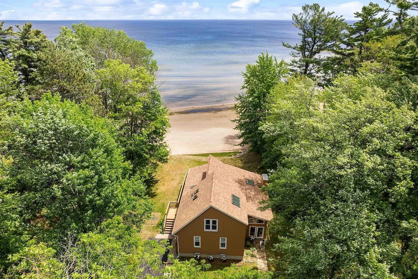 A house with a view of a beach and ocean.