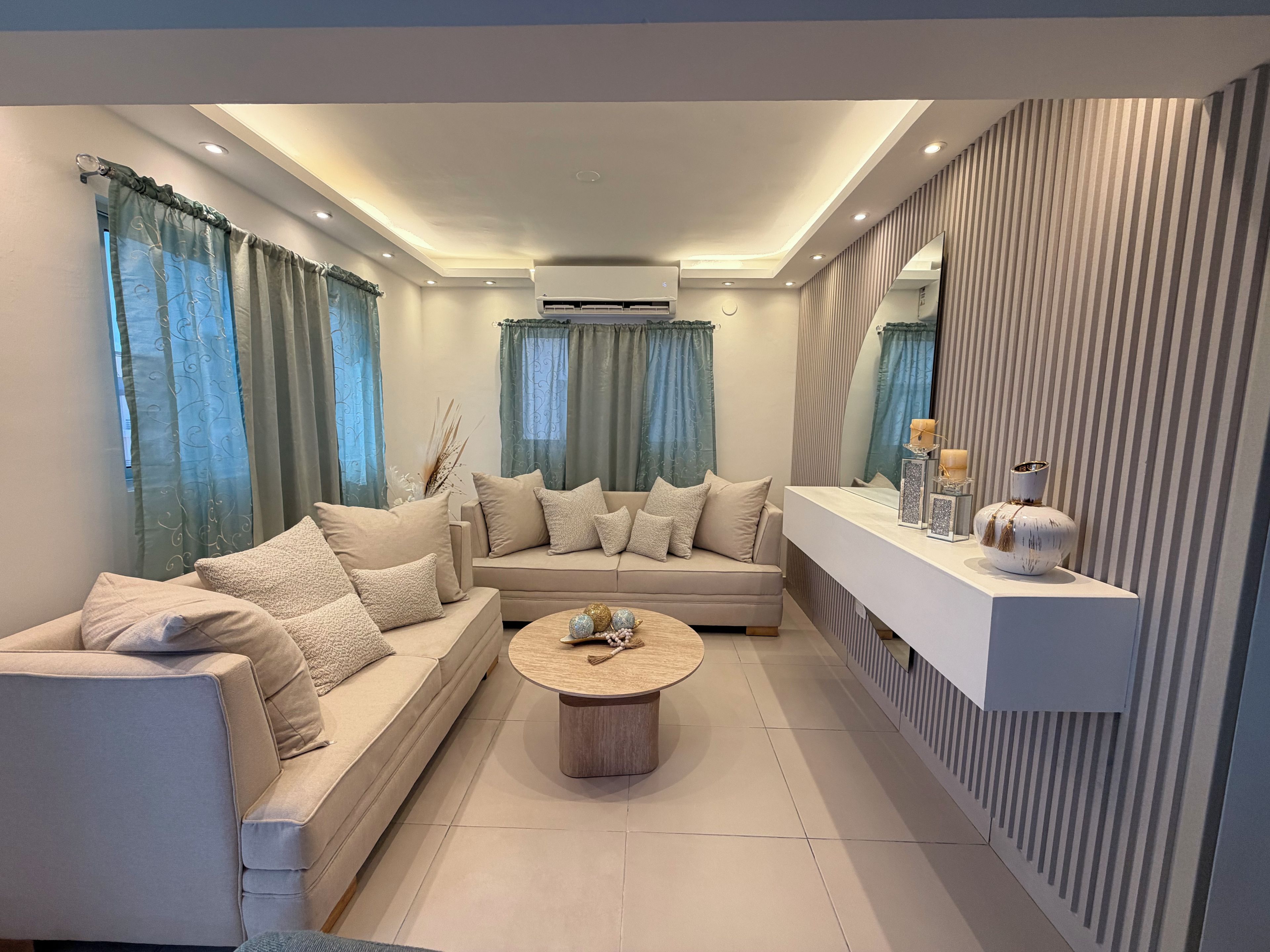 A modern living room with a sofa, coffee table, and decorative items.
