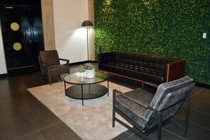 A modern living room with a sofa, armchair, and coffee table.