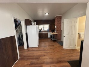 A compact kitchen with a refrigerator, microwave, and sink. - 4BR Home Near Philadelphia (Paulsboro)