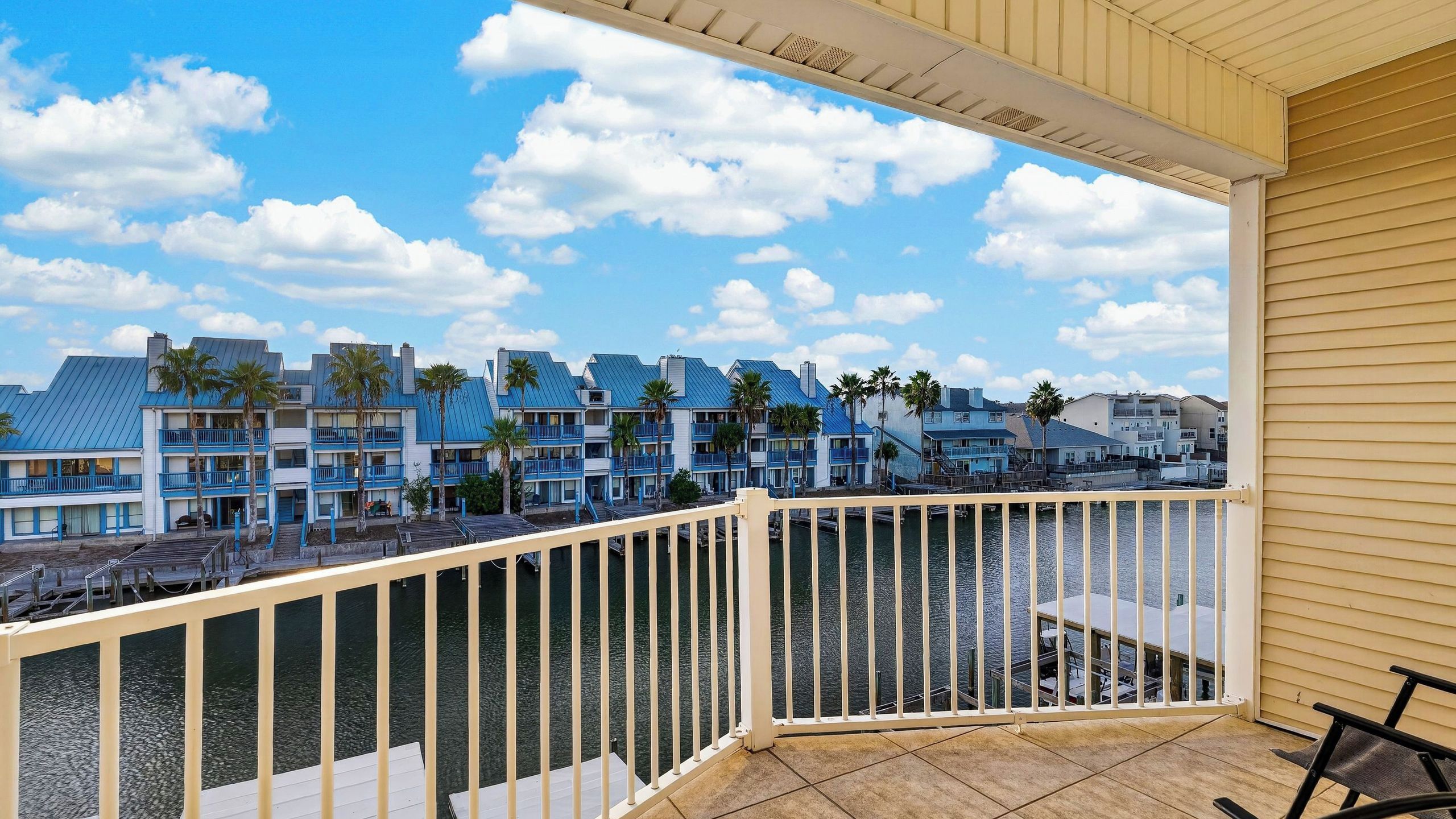 A balcony with a view of a coastal hotel complex.
