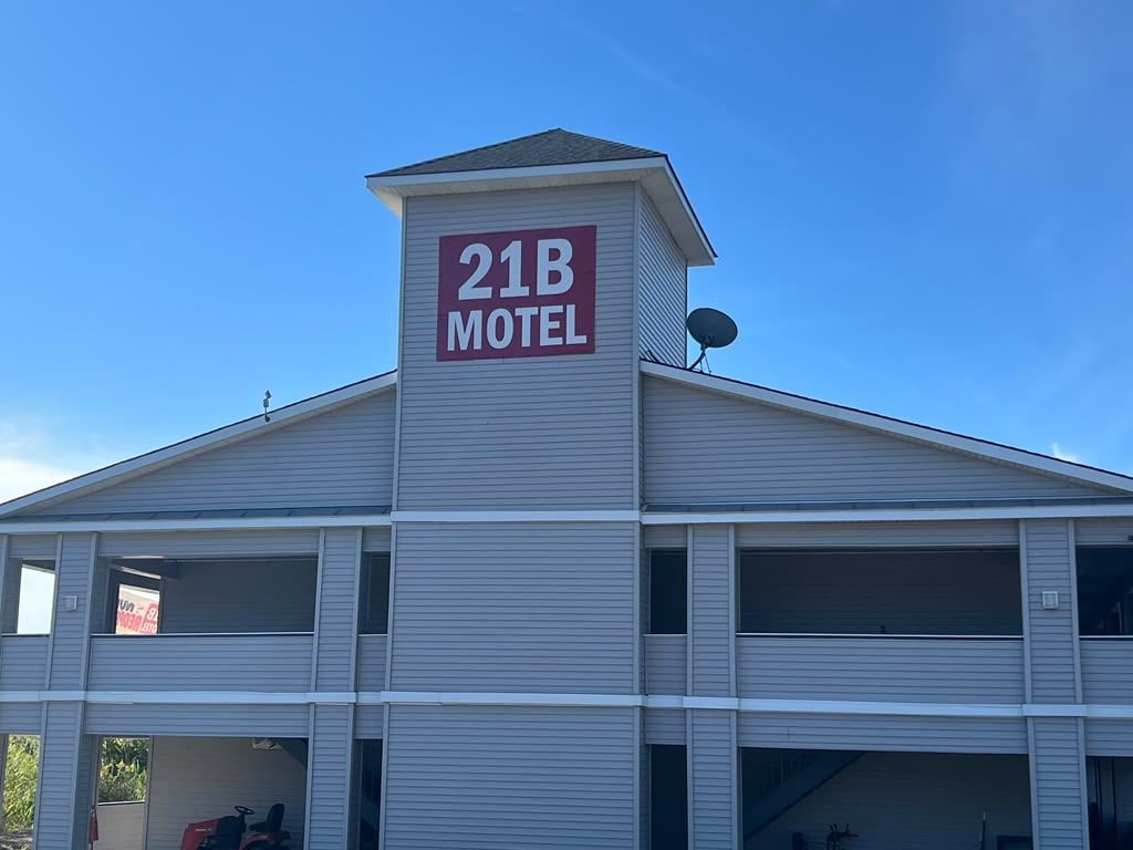 A motel with a prominent sign reading '21B MOTEL' on the roof.