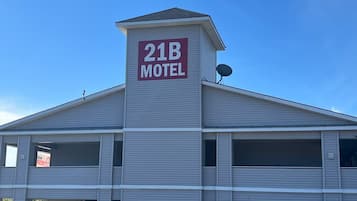 A motel with a prominent sign reading '21B MOTEL' on the roof.