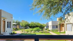 A residential area with modern houses, a well-maintained lawn, and a clear sky.