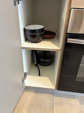 A kitchen with a built-in oven, a sink, and a countertop with a bowl and a pot. - Enjoy a modern and cozy studio apartment in Concepción. (Concepción)