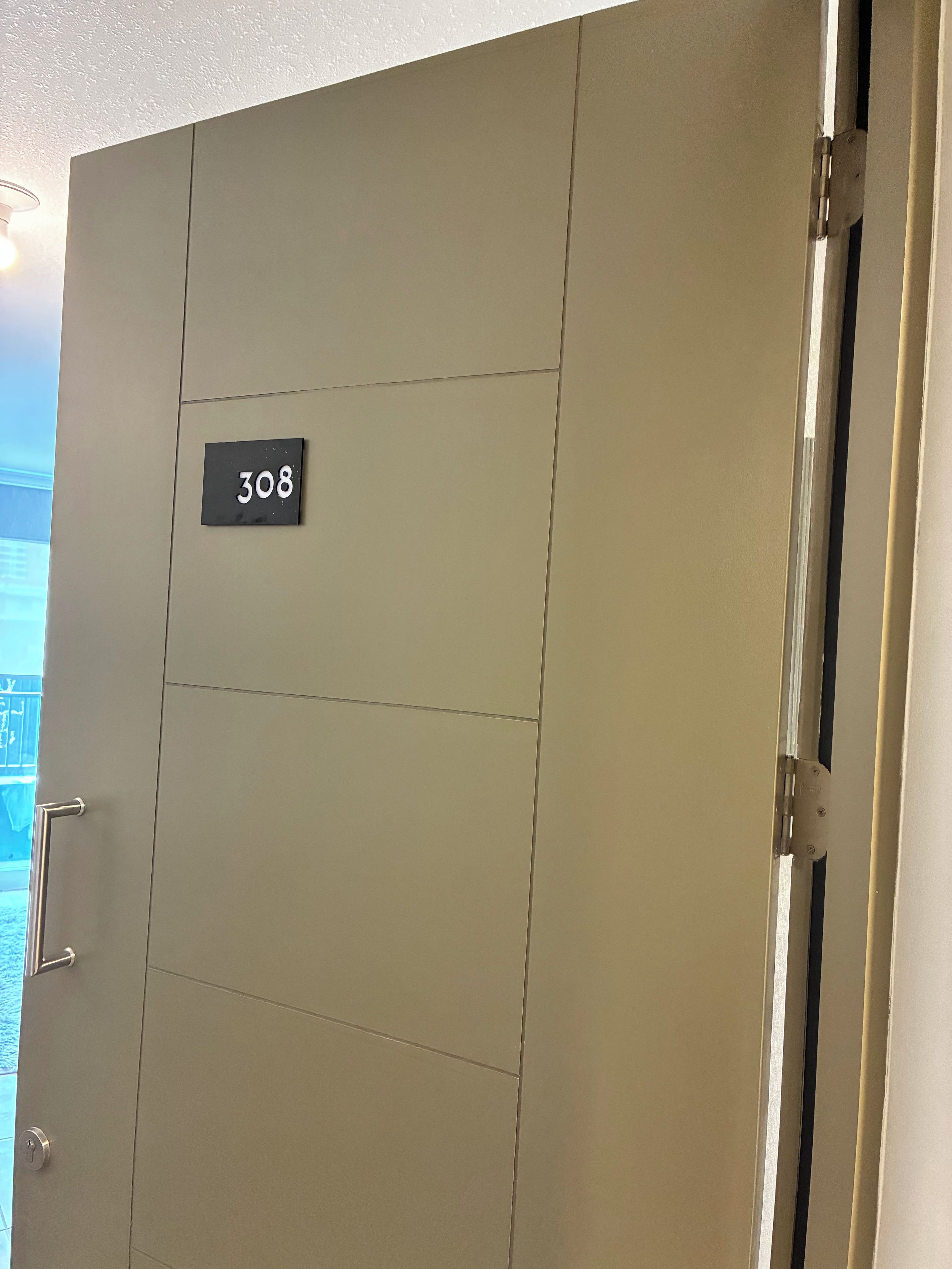A door with a number plate indicating room 308.