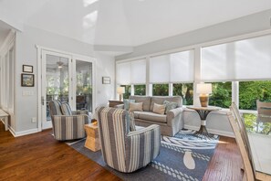 A spacious living room with a sofa set, striped armchairs, a coffee table, and a rug. - Palmetto Dunes Estate for 20, Heated Pool, EV Charger, 9 Min to Beach (Hilton Head Island)