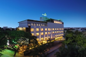 A multi-story hotel with illuminated windows and a rooftop sign.