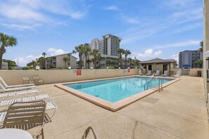 A swimming pool with lounge chairs and a no pets sign, surrounded by buildings and palm trees. - Summer Place 127 | Sleeps 6 | Great Fall Break Vacation! (Panama City)
