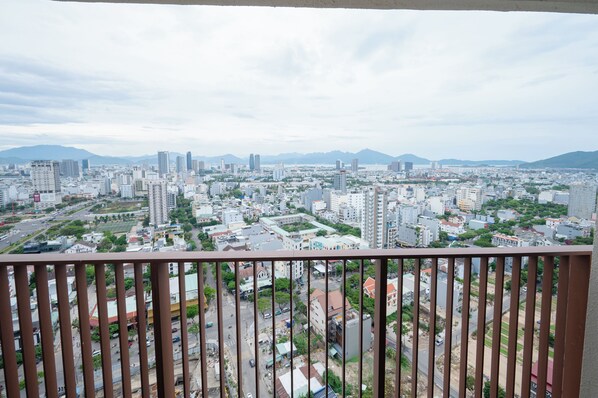A cityscape with a variety of building types, including high-rise apartments and commercial buildings, viewed from a balcony. - C Suite Soleil Da Nang - Free airport pick-up (An Hai)