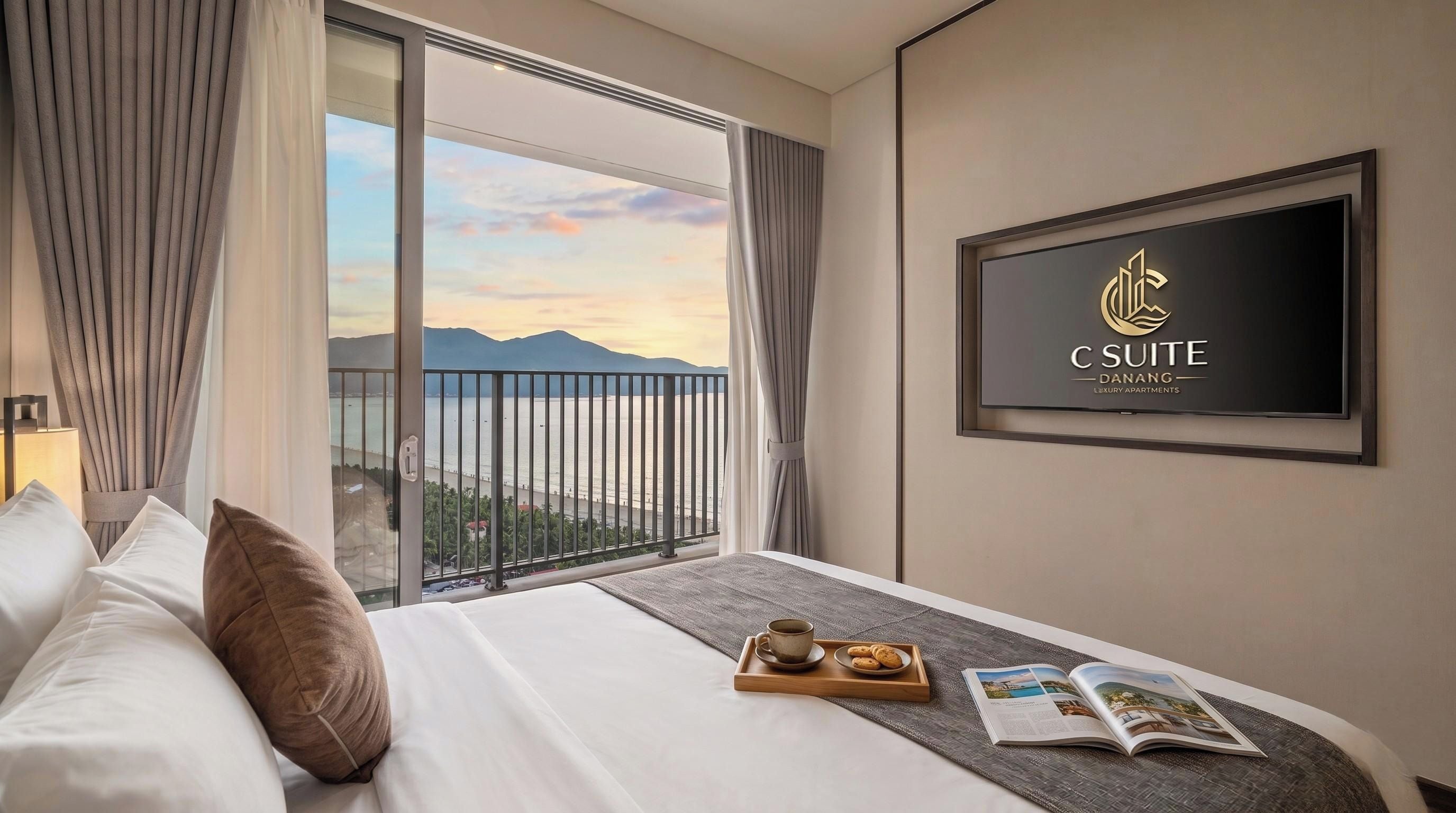 A hotel room with a bed, a tray with a cup and cookies, a magazine, and a TV displaying the hotel name.