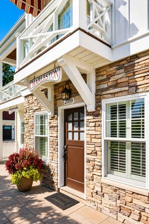 A stone building with a sign reading 'CHARLESTON' and the number '2059' above the door. - The Charleston | Pool • Hot Tub • Lake • Free Golf (Holland)