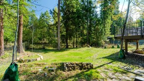 Uma área arborizada com um caminho de pedra que serpenteia por um espaço gramado.