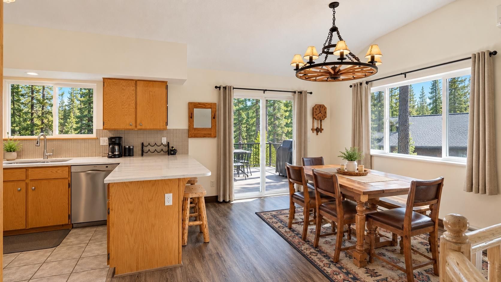 A modern kitchen with a central island, wooden cabinets, and a dining area with a table and chairs.