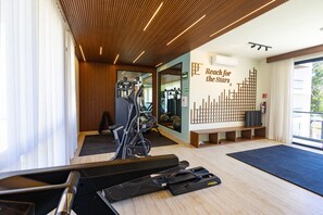A gym with exercise equipment, a wall with a 'Reach for the Stars' sign, and a wooden ceiling. - Fabulous Modern Luxury and Sophistication Penthouse, Temozon Norte (Merida)