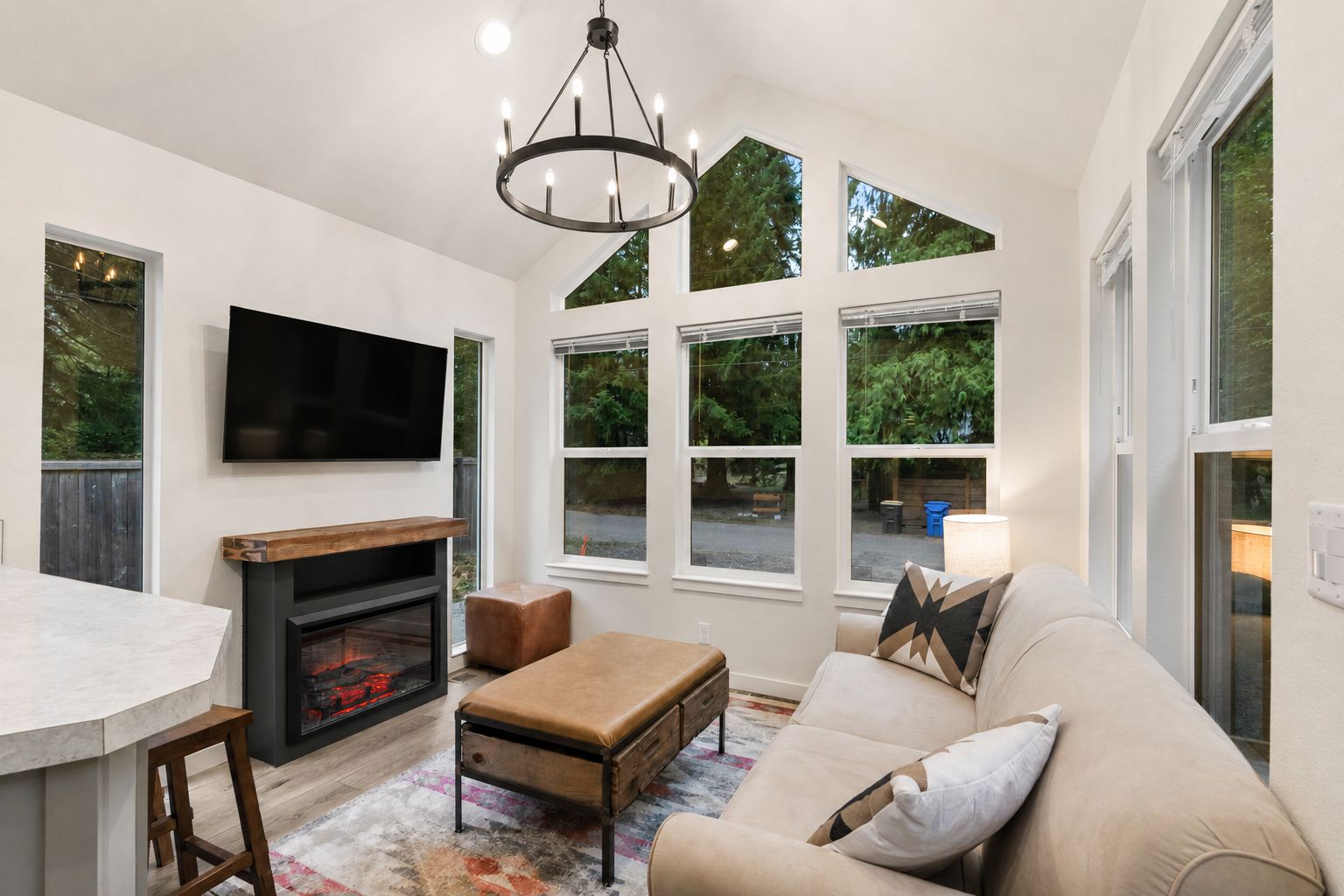 A modern living room with a fireplace, a television, and a sofa.