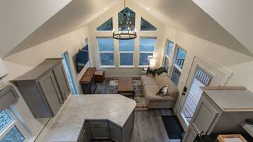 A spacious loft with a kitchen, dining area, and seating space.